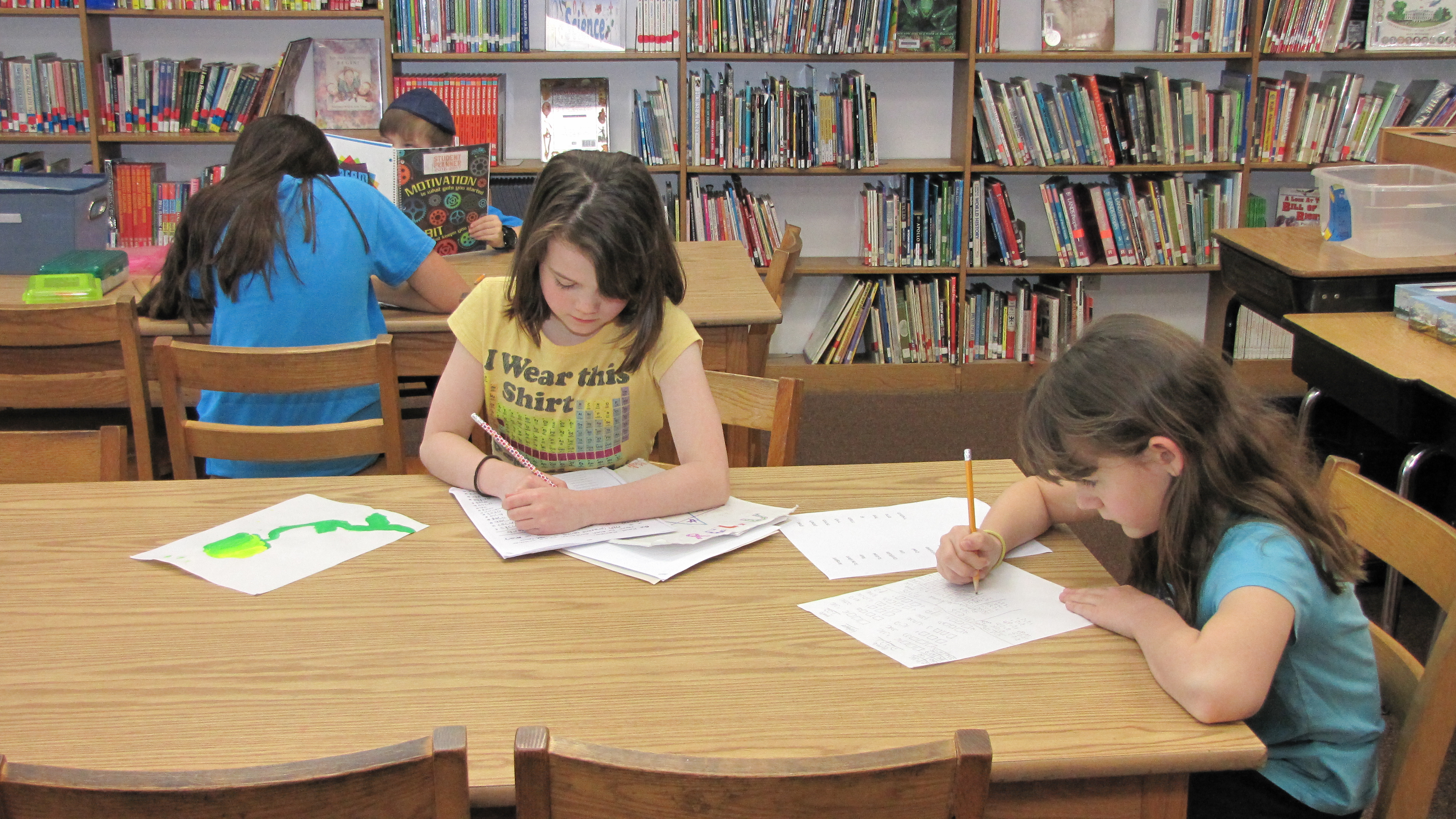 students do homework in a library